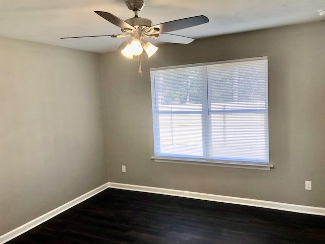 empty room featuring dark wood-type flooring and ceiling fan