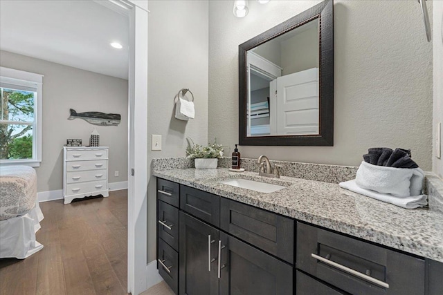 bathroom with hardwood / wood-style flooring and vanity