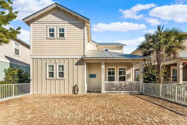 back of property featuring covered porch