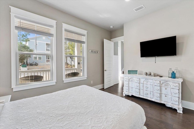 bedroom with dark hardwood / wood-style floors