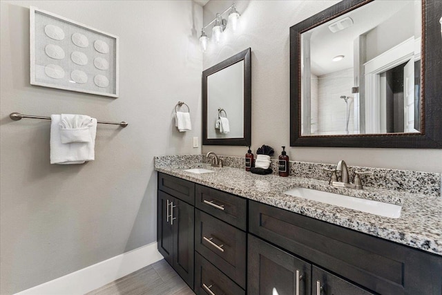 bathroom with vanity and a shower