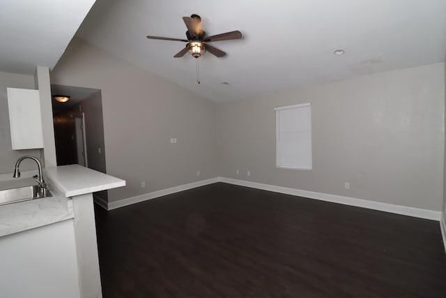 1944 Pasco St, Tallahassee, FL 32310 - unfurnished living room featuring a sink, dark wood-type flooring, a ceiling fan, vaulted ceiling, and baseboards