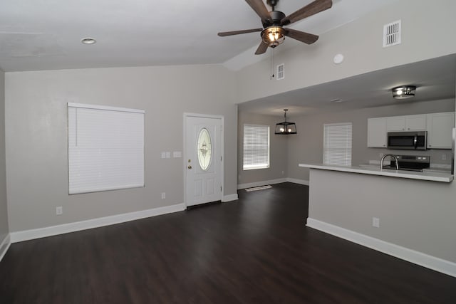 1944 Pasco St, Tallahassee, FL 32310 - unfurnished living room with dark wood finished floors, baseboards, a ceiling fan, high vaulted ceiling, and a sink