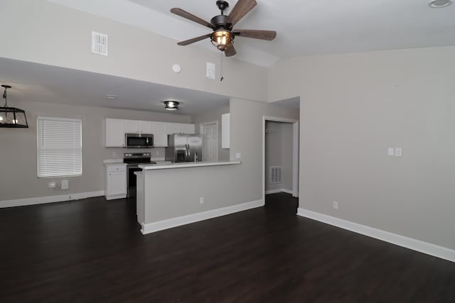 1944 Pasco St, Tallahassee, FL 32310 - kitchen with appliances with stainless steel finishes, baseboards, a ceiling fan, white cabinets, and dark wood-type flooring
