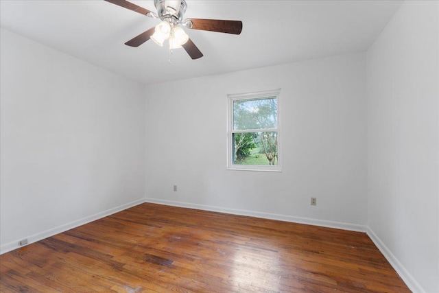 spare room with wood finished floors, baseboards, and ceiling fan