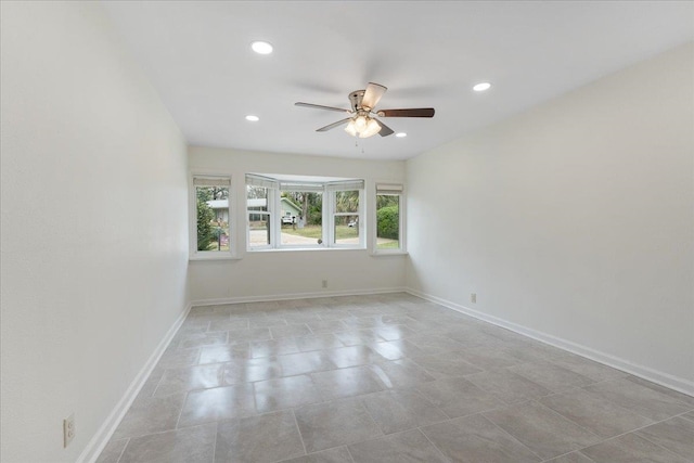 unfurnished room with recessed lighting, a ceiling fan, and baseboards