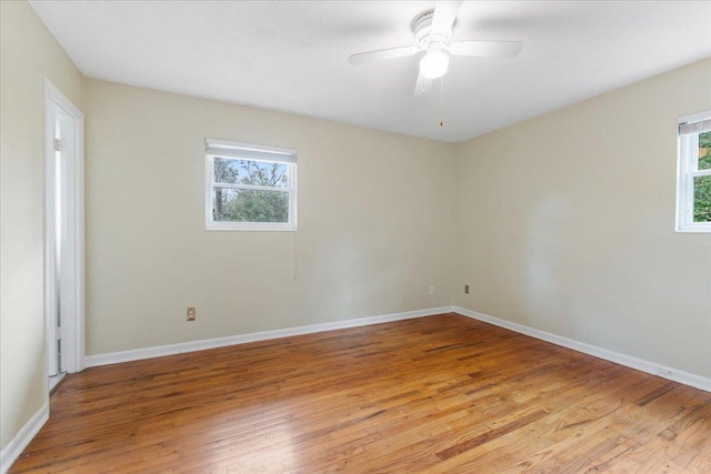 empty room with light wood finished floors and baseboards