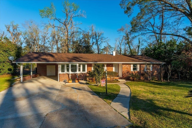 ranch-style home featuring a chimney, driveway, a front lawn, a carport, and brick siding