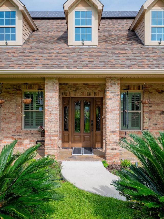 doorway to property featuring covered porch