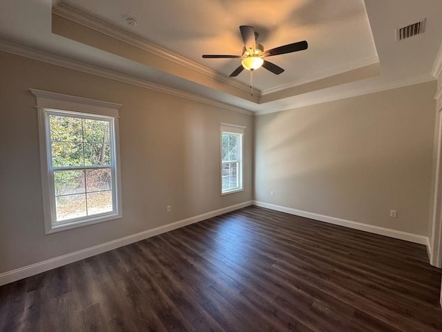 spare room with dark hardwood / wood-style floors, ceiling fan, and a tray ceiling