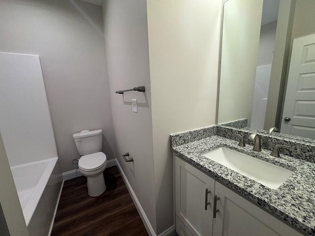 bathroom with vanity, hardwood / wood-style flooring, and toilet