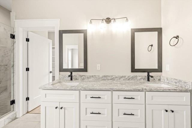 bathroom featuring vanity, tile patterned floors, and walk in shower