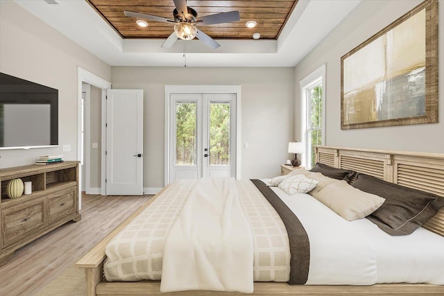5410 Peace Dove Trl, Tallahassee, FL 32311 - bedroom featuring a raised ceiling, light wood-style floors, baseboards, french doors, and access to outside