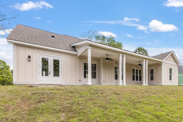 back of property with french doors, a yard, and ceiling fan