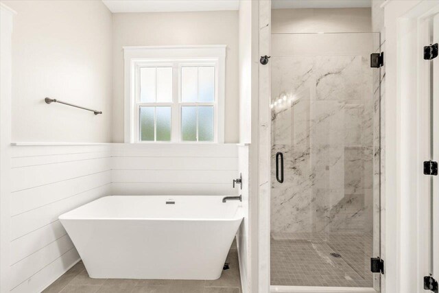 bathroom featuring tile patterned flooring and independent shower and bath