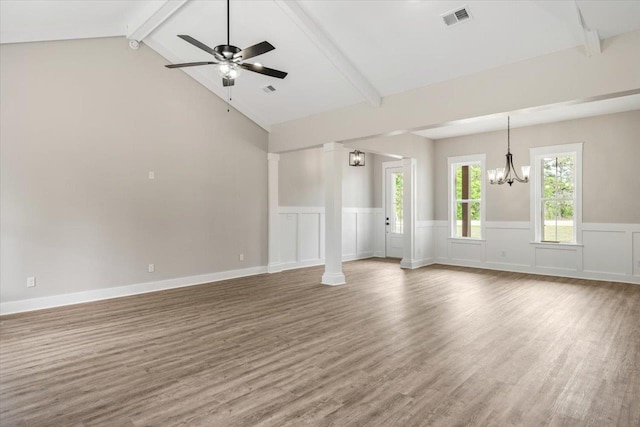 unfurnished living room featuring ceiling fan with notable chandelier and lofted ceiling with beams