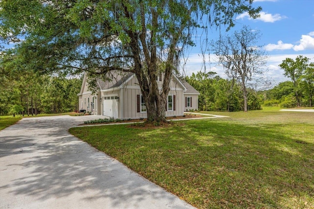 view of front of house with a garage and a front lawn