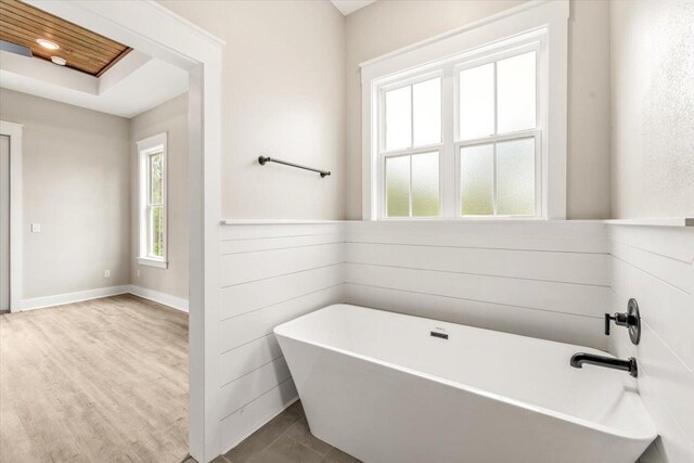 bathroom featuring tile patterned flooring and a bath