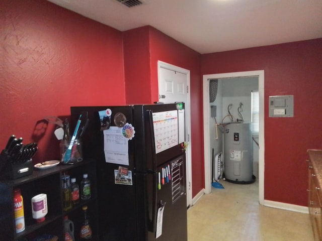 1508 Pepper Dr, Tallahassee, FL 32304 - miscellaneous room featuring water heater, light floors, and baseboards