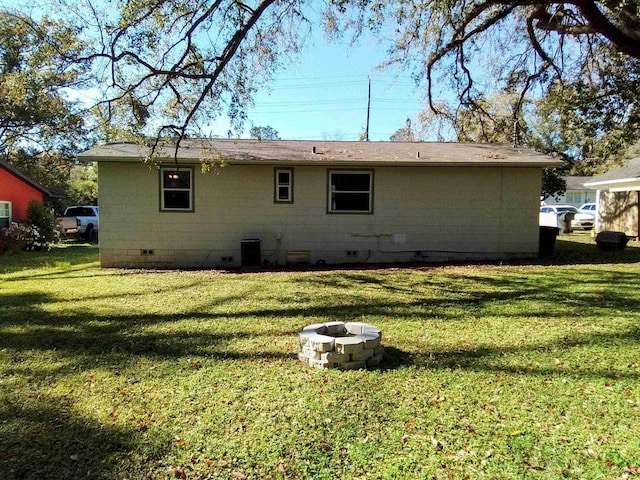 1508 Pepper Dr, Tallahassee, FL 32304 - rear view of property with crawl space, an outdoor fire pit, and a lawn