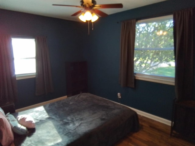 1508 Pepper Dr, Tallahassee, FL 32304 - bedroom with dark wood-style flooring, ceiling fan, and baseboards
