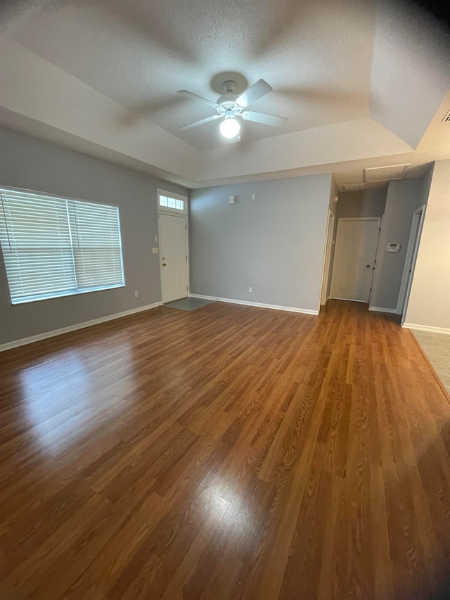 interior space featuring hardwood / wood-style floors, ceiling fan, and a textured ceiling