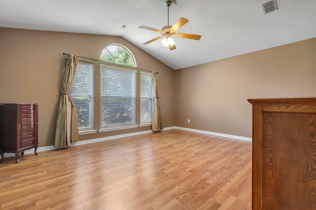 5529 Green Meadows Ct, Tallahassee, FL 32303 - empty room with vaulted ceiling, a ceiling fan, and light wood-type flooring