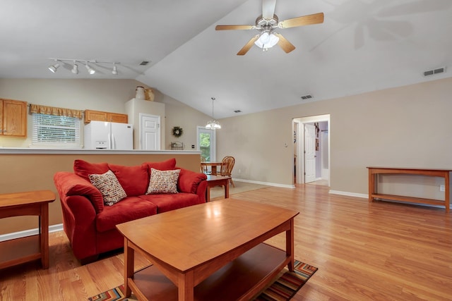 5529 Green Meadows Ct, Tallahassee, FL 32303 - living room featuring vaulted ceiling, light wood-style floors, ceiling fan, a chandelier, and rail lighting