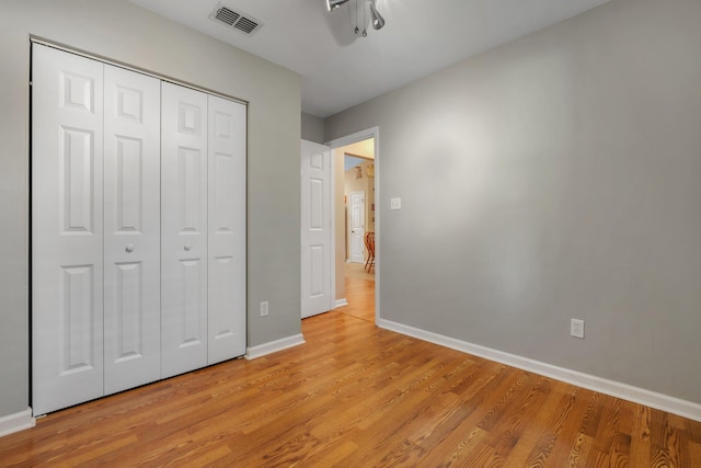 5529 Green Meadows Ct, Tallahassee, FL 32303 - unfurnished bedroom featuring light wood-style flooring, a closet, and a ceiling fan
