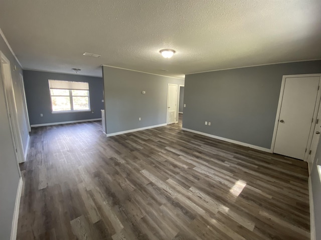 empty room featuring dark hardwood / wood-style flooring and a textured ceiling