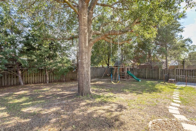 view of yard with a playground and a fenced backyard