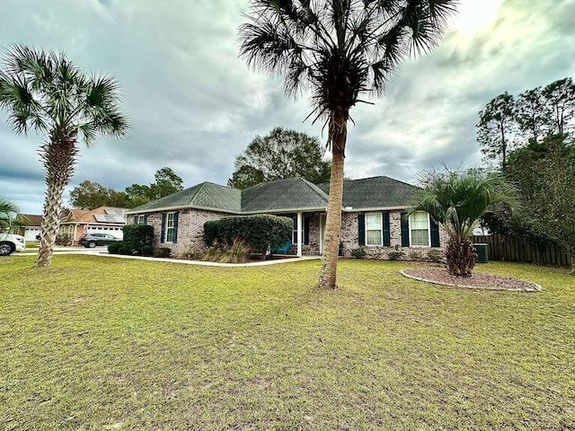 ranch-style house with brick siding, a front yard, and fence