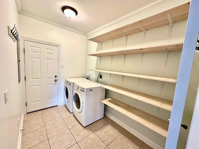 washroom with laundry area, light tile patterned floors, baseboards, crown molding, and separate washer and dryer