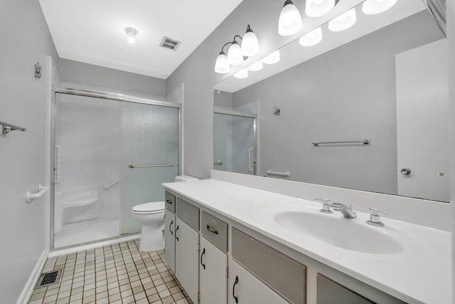 bathroom featuring toilet, vanity, tile patterned floors, and walk in shower