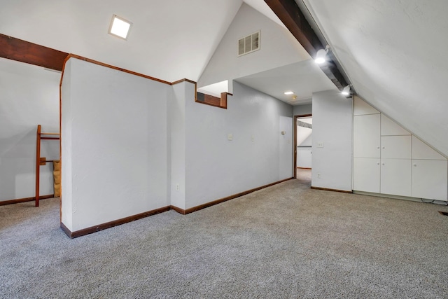 bonus room with light colored carpet and lofted ceiling