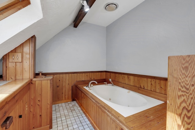 bathroom featuring wood walls, lofted ceiling with beams, tile patterned flooring, and a bath