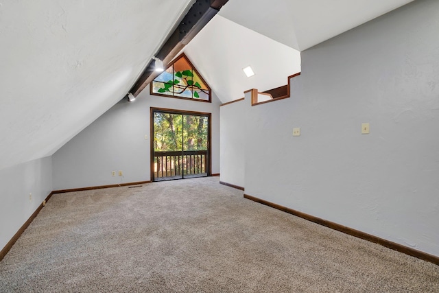 bonus room featuring lofted ceiling with beams and carpet