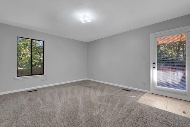 unfurnished room featuring light carpet