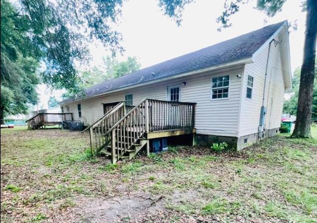 back of house featuring a wooden deck