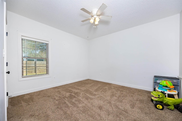 empty room with baseboards, a textured ceiling, ceiling fan, and carpet flooring