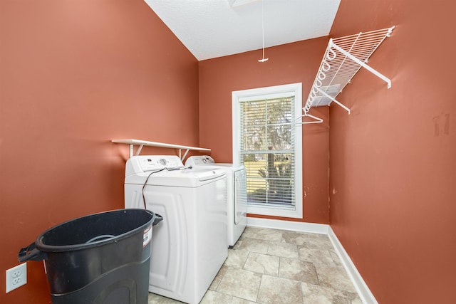 washroom featuring baseboards, independent washer and dryer, attic access, and laundry area