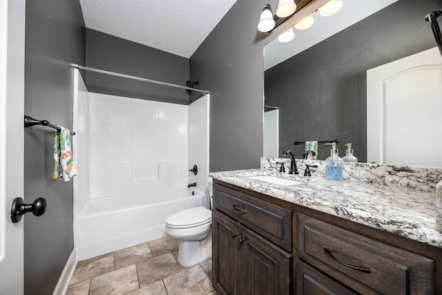 bathroom with baseboards, shower / washtub combination, toilet, vanity, and a textured ceiling