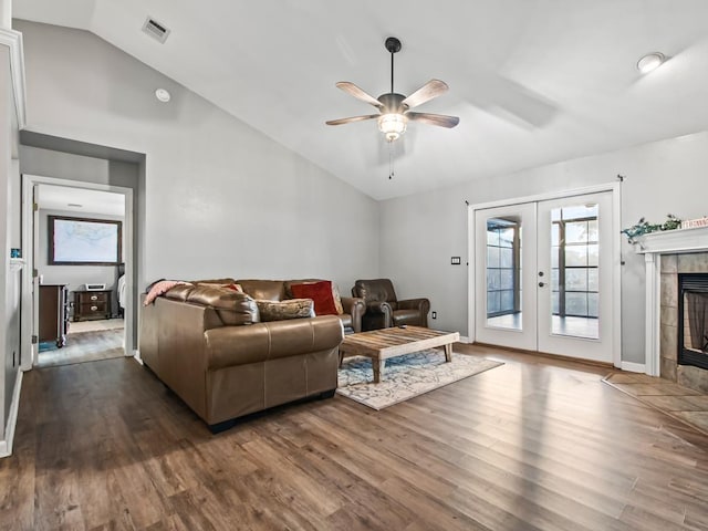 living room featuring lofted ceiling, dark wood-type flooring, ceiling fan, and french doors