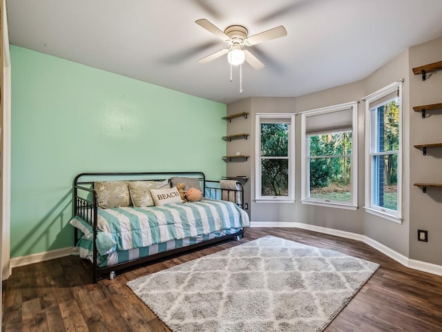 bedroom with dark wood-type flooring and ceiling fan