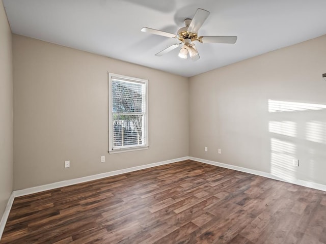 unfurnished room with dark hardwood / wood-style floors and ceiling fan