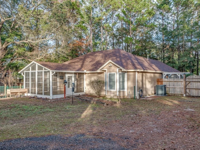 view of front of house featuring cooling unit and a sunroom