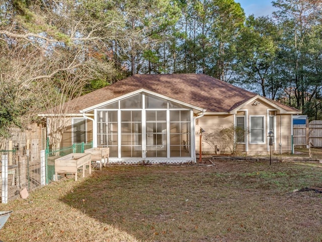 back of property with a sunroom