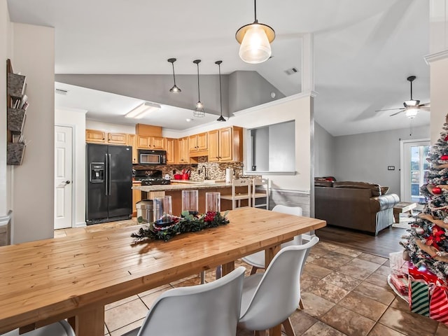 dining space with high vaulted ceiling and ceiling fan