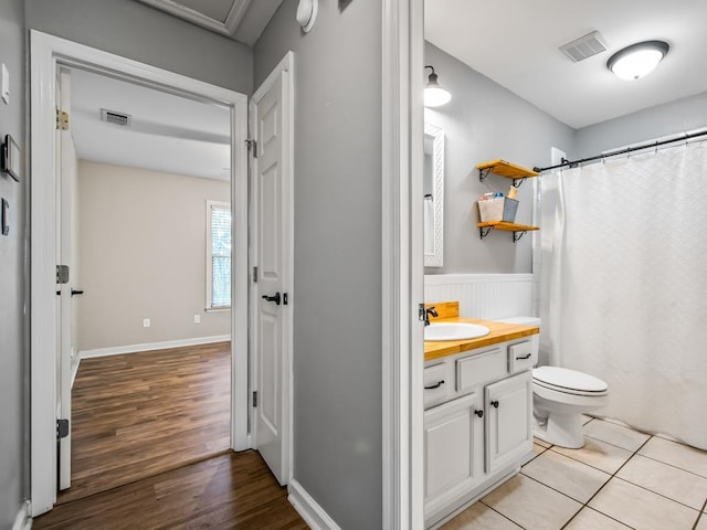 bathroom with vanity, a shower with curtain, tile patterned floors, and toilet