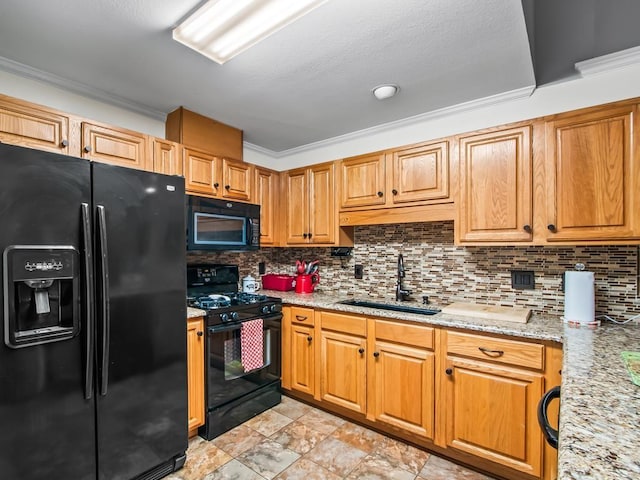 kitchen with sink, tasteful backsplash, crown molding, light stone counters, and black appliances